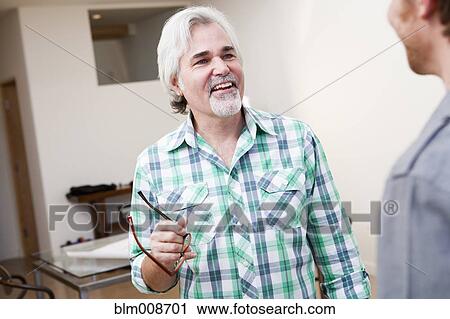 Stock Image - Caucasian architects talking in office. Fotosearch