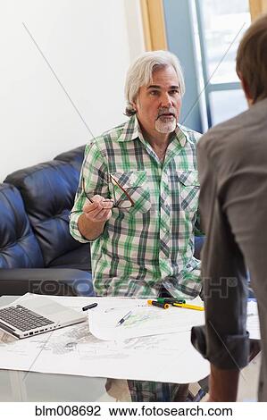 Stock Image - Caucasian architects working in office. Fotosearch