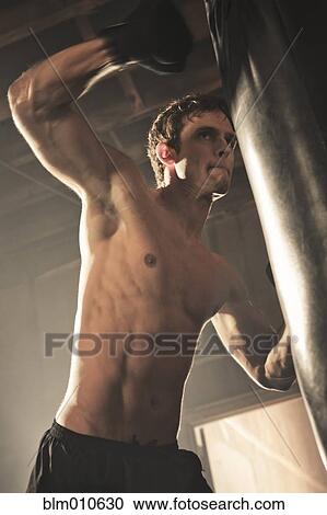 Caucasian boxer hitting punching bag View Large Photo Image Stock Image - Caucasian boxer hitting punching bag. Fotosearch