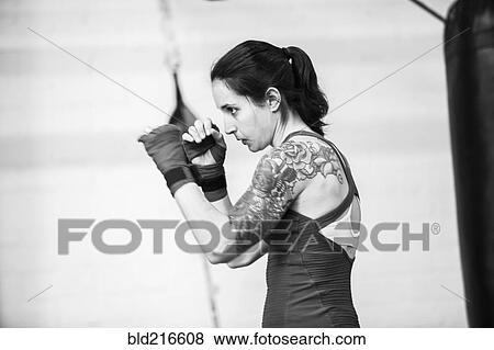 Stock Photo - Caucasian boxer training in gymnasium. Fotosearch