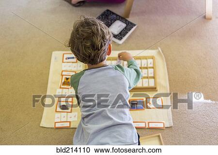 Caucasian boy arranging cards in classroom View Large Photo Image Stock Image - Caucasian boy arranging cards in classroom. Fotosearch