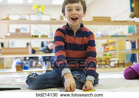 Caucasian boy playing in classroom View Large Photo Image Stock Image - Caucasian boy playing in classroom. Fotosearch