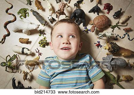 Caucasian boy surrounded near toy animals View Large Photo Image Stock Image - Caucasian boy surrounded near toy animals. Fotosearch