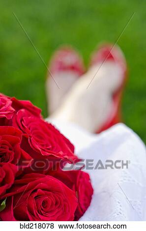 Stock Photo - Caucasian bride holding bouquet of flowers. Fotosearch