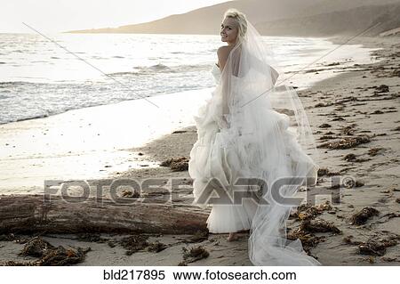 Caucasian bride walking on beach View Large Photo Image Stock Photography - Caucasian bride walking on beach. Fotosearch