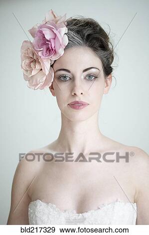 Stock Photo - Caucasian bride wearing flower in hair. Fotosearch