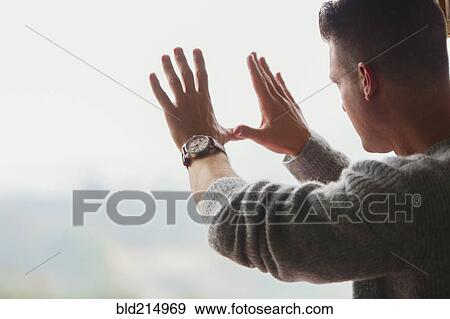 Stock Photo - Caucasian businessman framing with hands. Fotosearch
