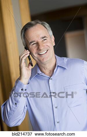 Stock Photo - Caucasian businessman talking on cell phone. Fotosearch