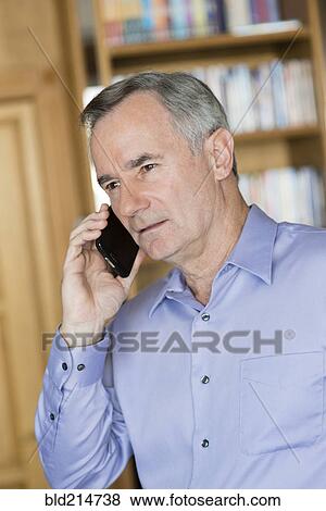 Stock Photo - Caucasian businessman talking on cell phone. Fotosearch