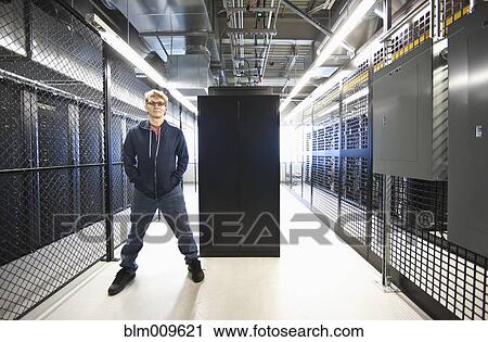 Stock Image - Caucasian businessman working in office technology room. Fotosearch