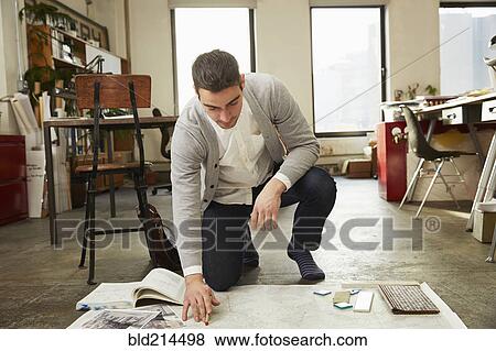 Caucasian businessman working on floor in office View Large Photo Image Stock Photo - Caucasian businessman working on floor in office. Fotosearch