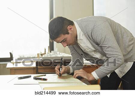 Caucasian businessman writing on desk in office View Large Photo Image Stock Photo - Caucasian businessman writing on desk in office. Fotosearch