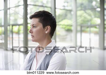 Stock Photo - Caucasian businesswoman in lobby. Fotosearch