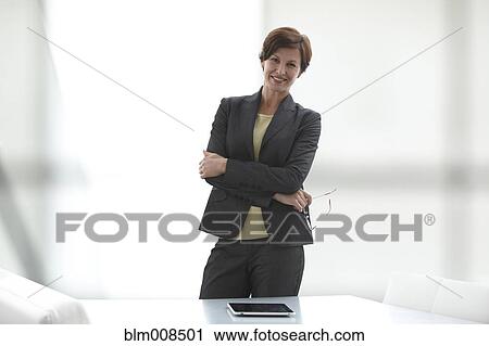 Caucasian businesswoman standing with arms crossed View Large Photo Image Stock Image - Caucasian businesswoman standing with arms crossed. Fotosearch
