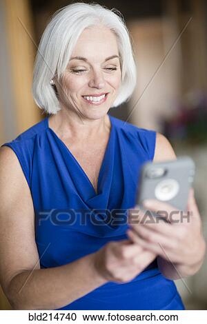 Stock Image - Caucasian businesswoman using cell phone. Fotosearch