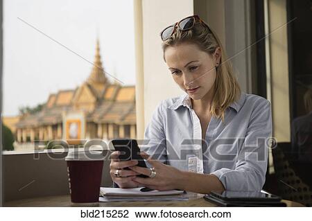 Caucasian businesswoman using cell phone in cafe, Phnom Penh, Cambodia View Large Photo Image Stock Image - Caucasian businesswoman using cell phone in cafe, Phnom Penh, Cambodia. Fotosearch