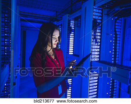Caucasian businesswoman using digital tablet in server room View Large Photo Image Stock Photo - Caucasian businesswoman using digital tablet in server room. Fotosearch