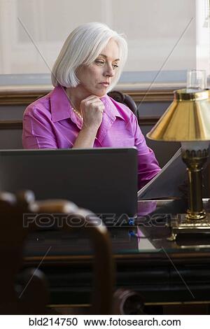 Caucasian businesswoman working at office desk View Large Photo Image Stock Image - Caucasian businesswoman working at office desk. Fotosearch