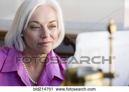 Caucasian businesswoman working at office desk View Large Photo Image Stock Image - Caucasian businesswoman working at office desk. Fotosearch