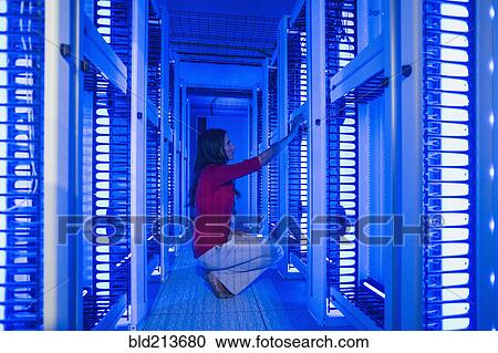 Stock Image - Caucasian businesswoman working in server room. Fotosearch