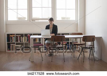 Caucasian businesswoman working on laptop in office View Large Photo Image Stock Photo - Caucasian businesswoman working on laptop in office. Fotosearch