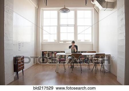 Stock Photo - Caucasian businesswoman working on laptop in office. Fotosearch