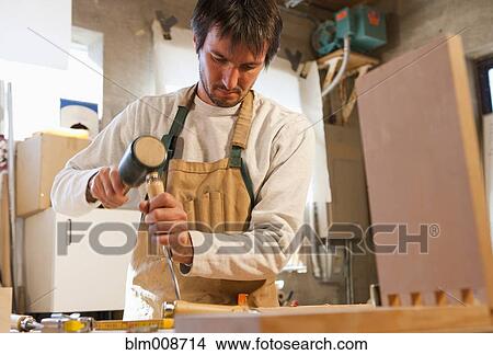 Caucasian carpenter working in workshop View Large Photo Image Picture - Caucasian carpenter working in workshop. Fotosearch
