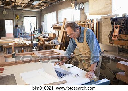 Caucasian carpenter working in workshop View Large Photo Image Stock Image - Caucasian carpenter working in workshop. Fotosearch