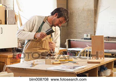 Caucasian carpenter working in workshop View Large Photo Image Stock Photo - Caucasian carpenter working in workshop. Fotosearch