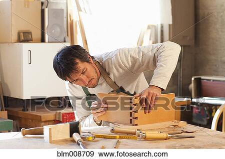 Caucasian carpenter working in workshop View Large Photo Image Stock Photo - Caucasian carpenter working in workshop. Fotosearch