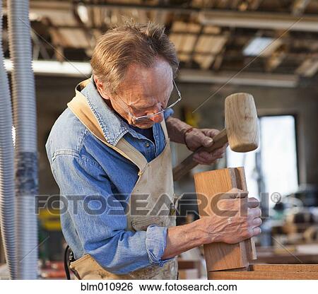 Caucasian carpenter working in workshop View Large Photo Image Stock Photograph - Caucasian carpenter working in workshop. Fotosearch