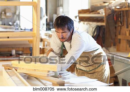 Caucasian carpenter working in workshop View Large Photo Image Stock Photography - Caucasian carpenter working in workshop. Fotosearch