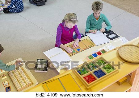 Caucasian children at table in classroom View Large Photo Image Stock Photo - Caucasian children at table in classroom. Fotosearch
