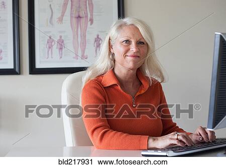 Caucasian chiropractor working at computer View Large Photo Image Stock Image - Caucasian chiropractor working at computer. Fotosearch