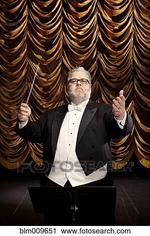 Caucasian conductor at podium View Large Photo Image Stock Image - Caucasian conductor at podium. Fotosearch