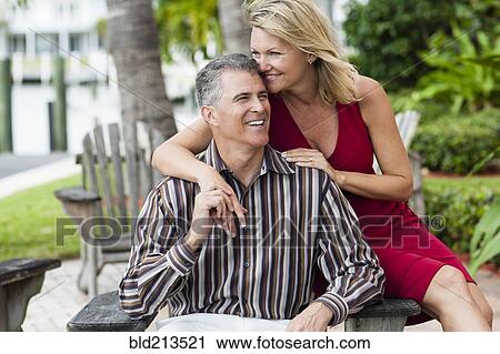 Stock Image - Caucasian couple hugging outdoors. Fotosearch