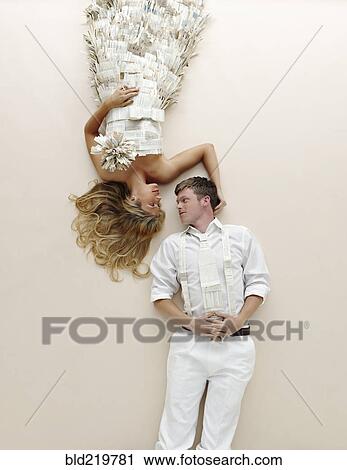 Stock Image - Caucasian couple laying on floor. Fotosearch
