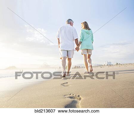 Caucasian couple leaving footprints on beach View Large Photo Image Stock Photo - Caucasian couple leaving footprints on beach. Fotosearch