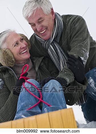 Caucasian couple sledding in snow together View Large Photo Image Stock Image - Caucasian couple sledding in snow together. Fotosearch