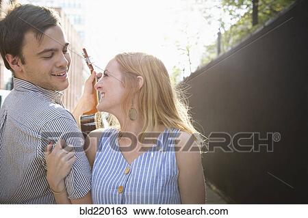 Stock Image - Caucasian couple standing in city. Fotosearch