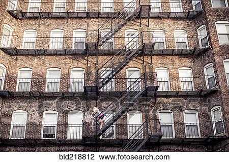 Caucasian couple standing on apartment fire escape View Large Photo Image Stock Image - Caucasian couple standing on apartment fire escape. Fotosearch