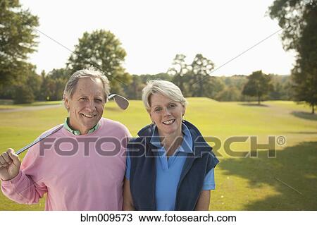 Caucasian couple standing on golf course View Large Photo Image Stock Image - Caucasian couple standing on golf course. Fotosearch