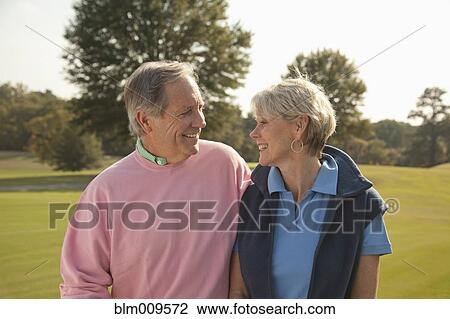 Caucasian couple standing together outdoors View Large Photo Image Stock Image - Caucasian couple standing together outdoors. Fotosearch