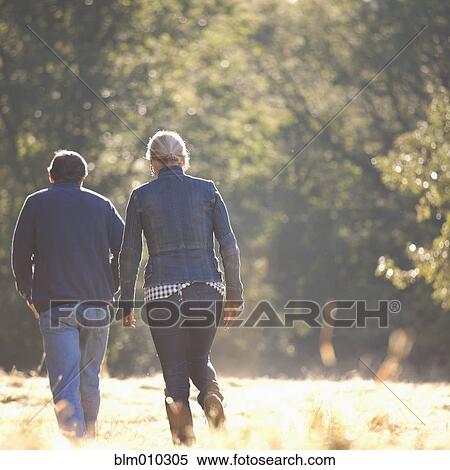 Caucasian couple walking together outdoors View Large Photo Image Stock Photography - Caucasian couple walking together outdoors. Fotosearch