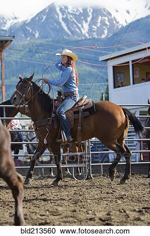 Caucasian cowgirl riding horse in rodeo on ranch View Large Photo Image Stock Image - Caucasian cowgirl riding horse in rodeo on ranch. Fotosearch