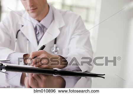 Caucasian doctor writing in medical record View Large Photo Image Stock Photograph - Caucasian doctor writing in medical record. Fotosearch