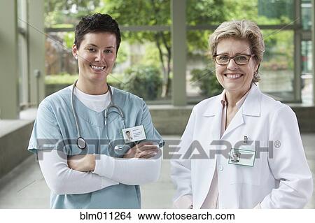 Caucasian doctors standing together in lobby View Large Photo Image Picture - Caucasian doctors standing together in lobby. Fotosearch