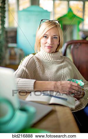 Caucasian entrepreneur drinking cup of coffee in shop View Large Photo Image Stock Photo - Caucasian entrepreneur drinking cup of coffee in shop. Fotosearch