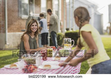 Caucasian family eating in backyard View Large Photo Image Stock Photo - Caucasian family eating in backyard. Fotosearch