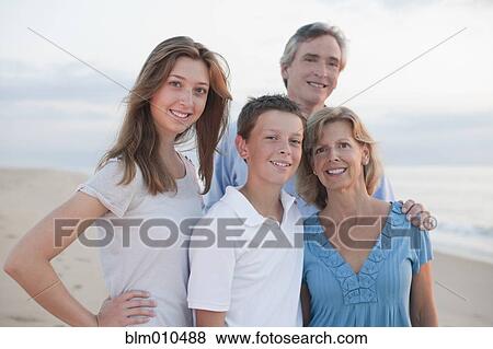Caucasian family enjoying beach View Large Photo Image Stock Photo - Caucasian family enjoying beach. Fotosearch